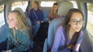 4 teens driving in a car