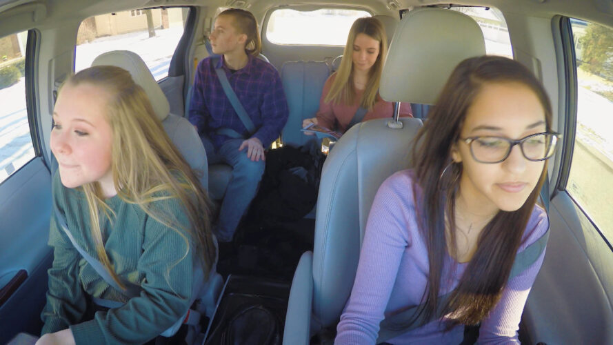 4 teens driving in a car