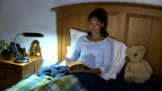Christin studying in bed
