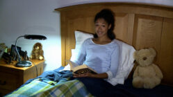 Christin studying in bed