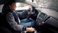 Young man driving and texting