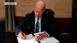 President Biden signing papers