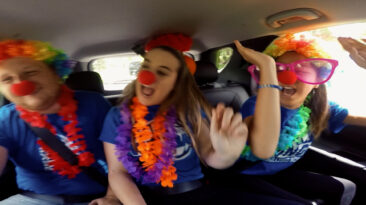 Teens clowning around in a car
