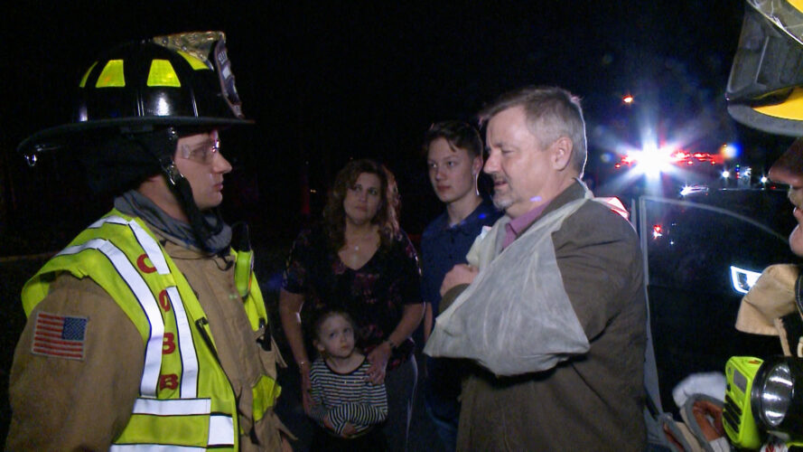 Emergency responders attend to an injured driver