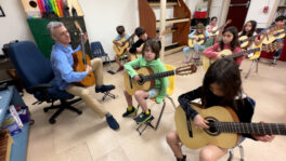 Guitar teacher in a classroom