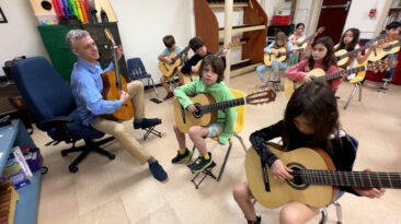 Guitar teacher in a classroom