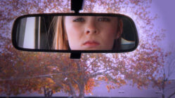 Girls eyes as seen in a rear view mirror