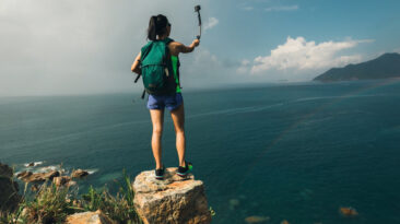 Girl on a ledge taking a selfie