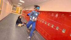 A Superhero runs through his high school hallway