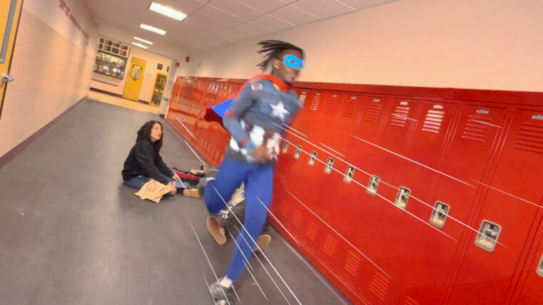 A Superhero runs through his high school hallway