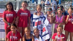 Swimmers pose for a photo