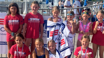 Swimmers pose for a photo