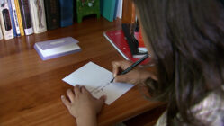 a girl shows off her handwriting skills